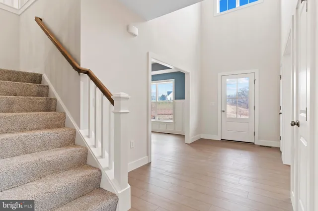 a view of an entryway with wooden floor and door