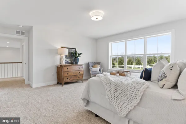 a bedroom with a bed and a couch