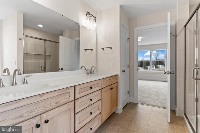 a bathroom with a window and a shower