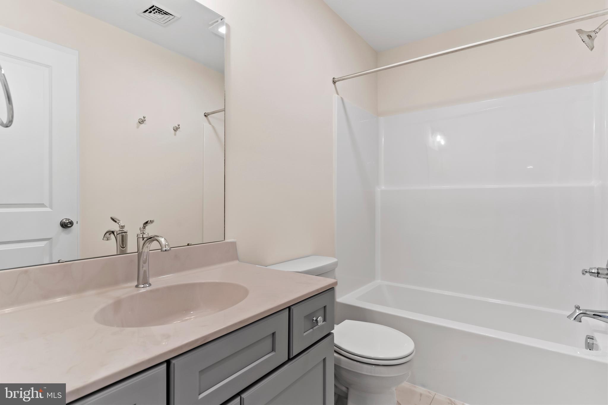 302 Cedar Road Dillsburg, PA 17019 - Photo 38 of 54 a bathroom with a sink a toilet and a large mirror