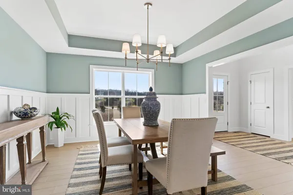 a view of a dining room with furniture wooden floor and chandelier