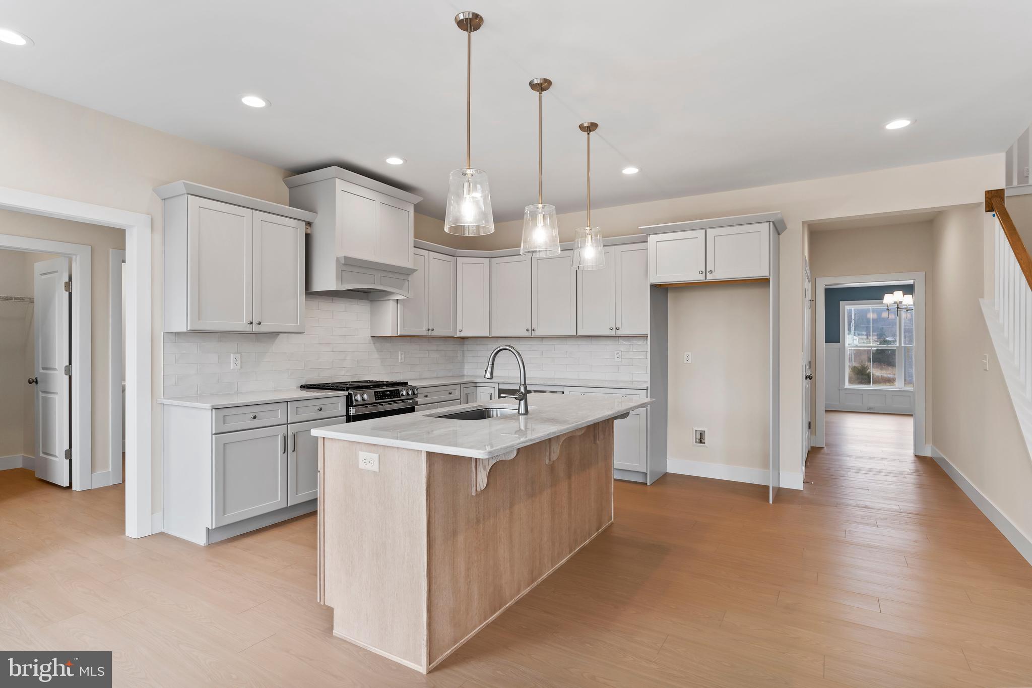 302 Cedar Road Dillsburg, PA 17019 - Photo 7 of 54 a kitchen with stainless steel appliances granite countertop a sink a stove a refrigerator and white cabinets