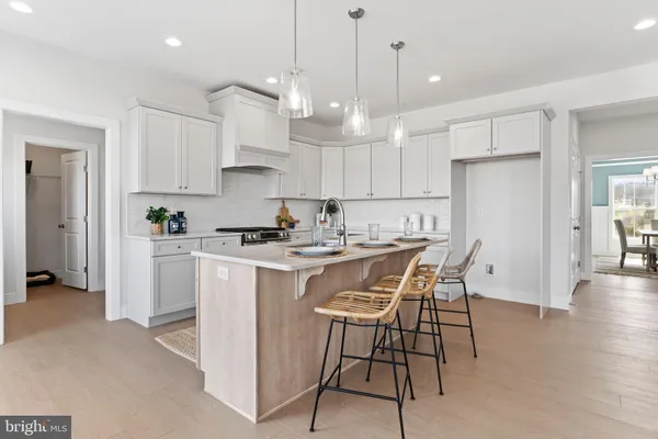 a kitchen with stainless steel appliances granite countertop a sink and a refrigerator