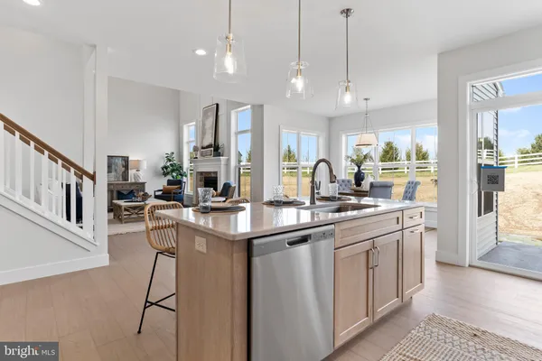 a dining table with chairs and kitchen view