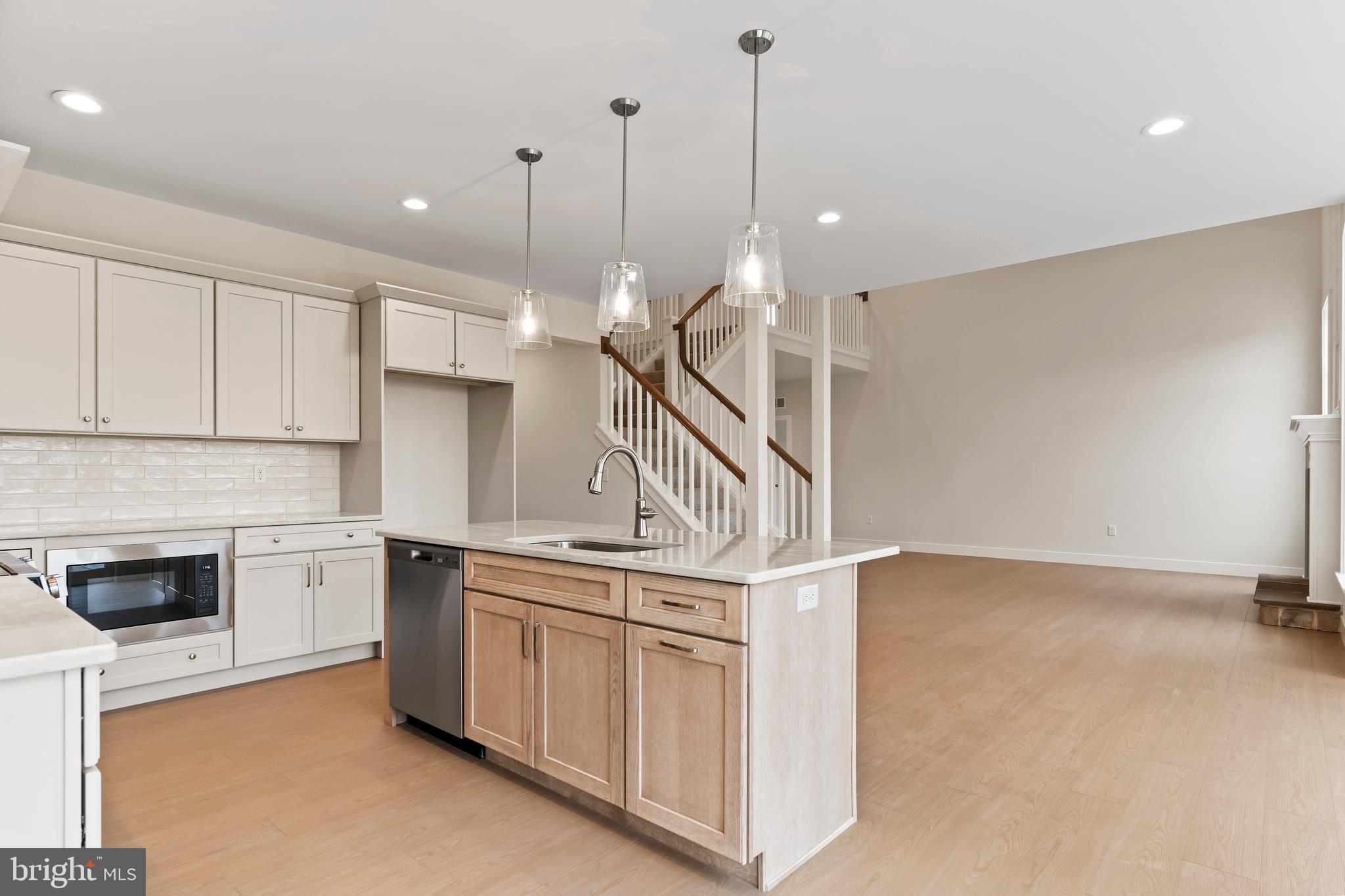 302 Cedar Road Dillsburg, PA 17019 - Photo 10 of 54 a kitchen with stainless steel appliances granite countertop a sink a stove and a wooden floors