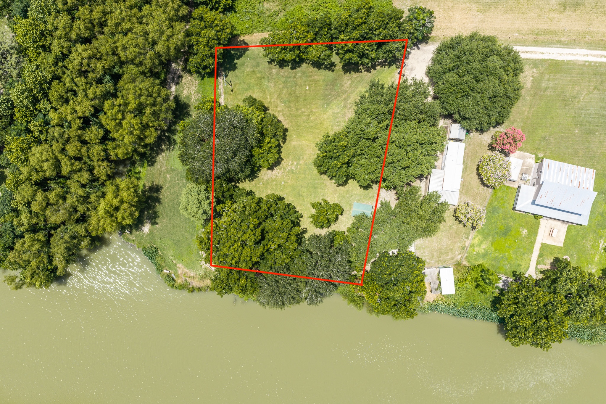 Tbd Goodwin Road Gonzales, TX 78629 - Photo 1 of 33 A verdant, well-maintained parcel offers tranquil waterside living with mature shade trees.