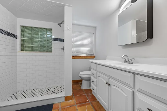 a bathroom with a sink toilet and shower