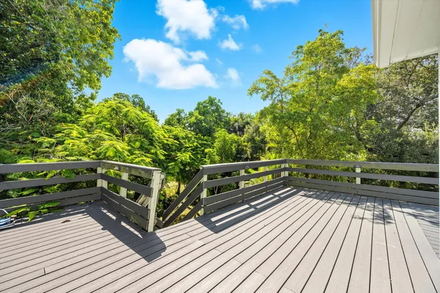 a view of a balcony with wooden floor and bench