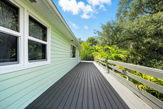 a view of balcony with wooden floor