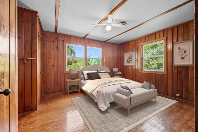 a bedroom with a large bed and a window