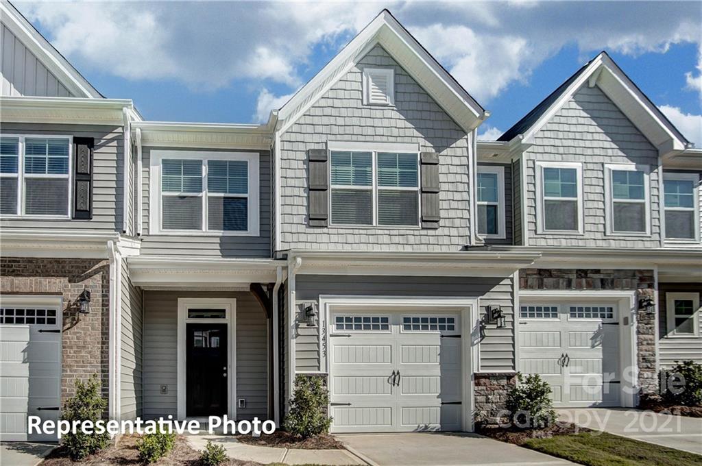 2153 Bexar Trail Matthews, NC 28105 - Photo 2 of 35 a view of a brick house with large windows