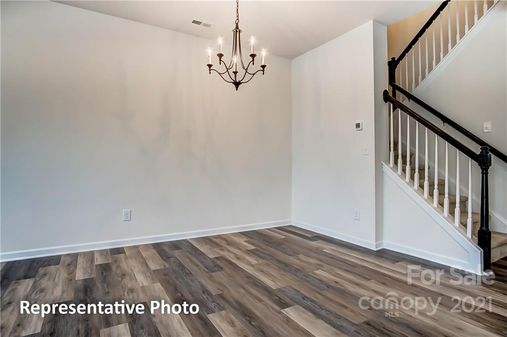 2153 Bexar Trail Matthews, NC 28105 - Photo 13 of 35 a view of a room with wooden floor and staircase