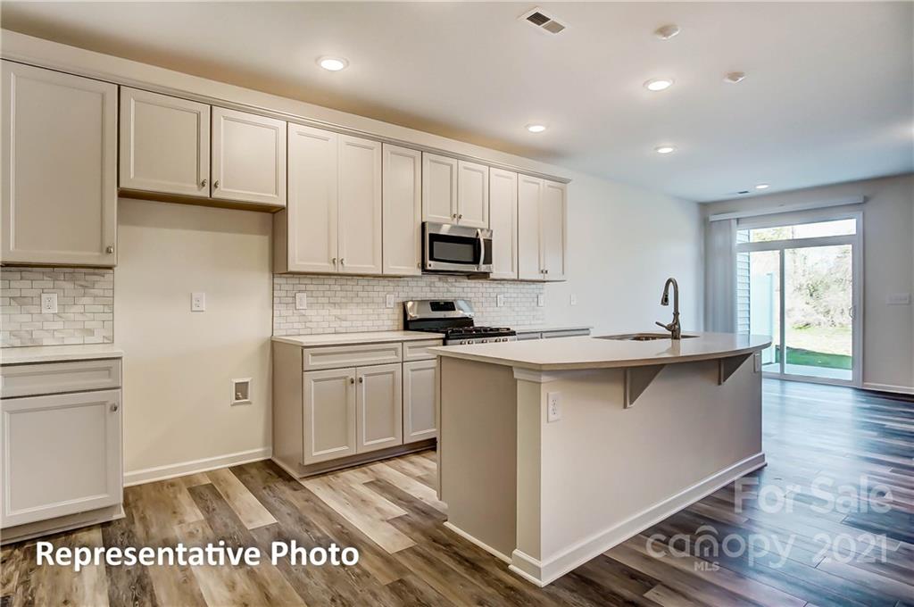 2153 Bexar Trail Matthews, NC 28105 - Photo 16 of 35 a kitchen with appliances cabinets and a sink