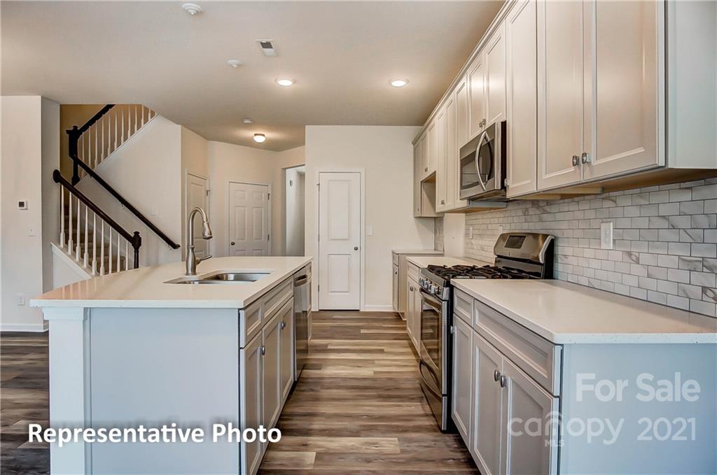 2153 Bexar Trail Matthews, NC 28105 - Photo 17 of 35 a kitchen with stainless steel appliances granite countertop a sink and cabinets