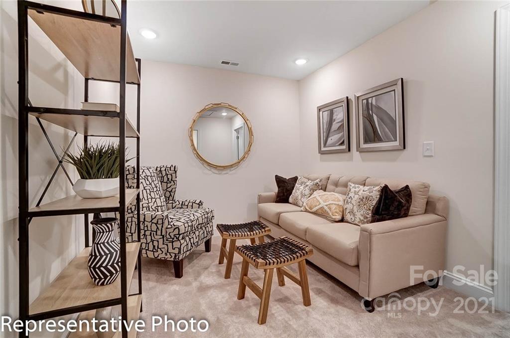 2153 Bexar Trail Matthews, NC 28105 - Photo 25 of 35 a living room with furniture and paintings on the wall