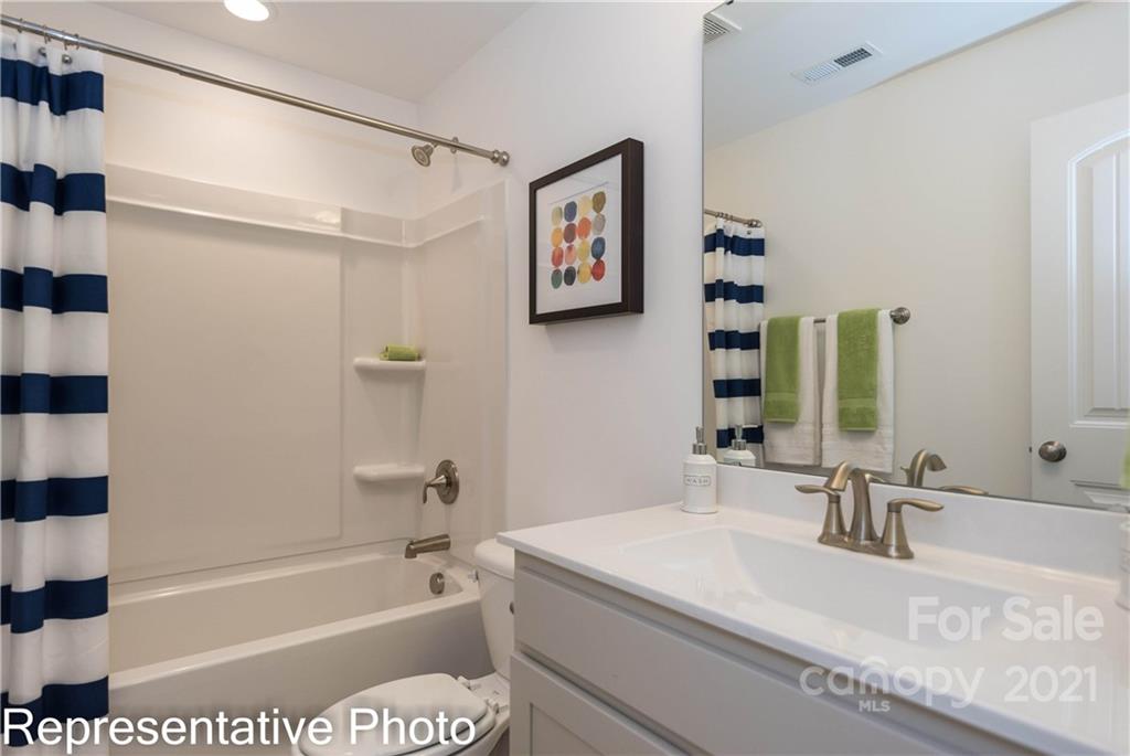 2153 Bexar Trail Matthews, NC 28105 - Photo 35 of 35 a bathroom with a tub a sink and a large mirror