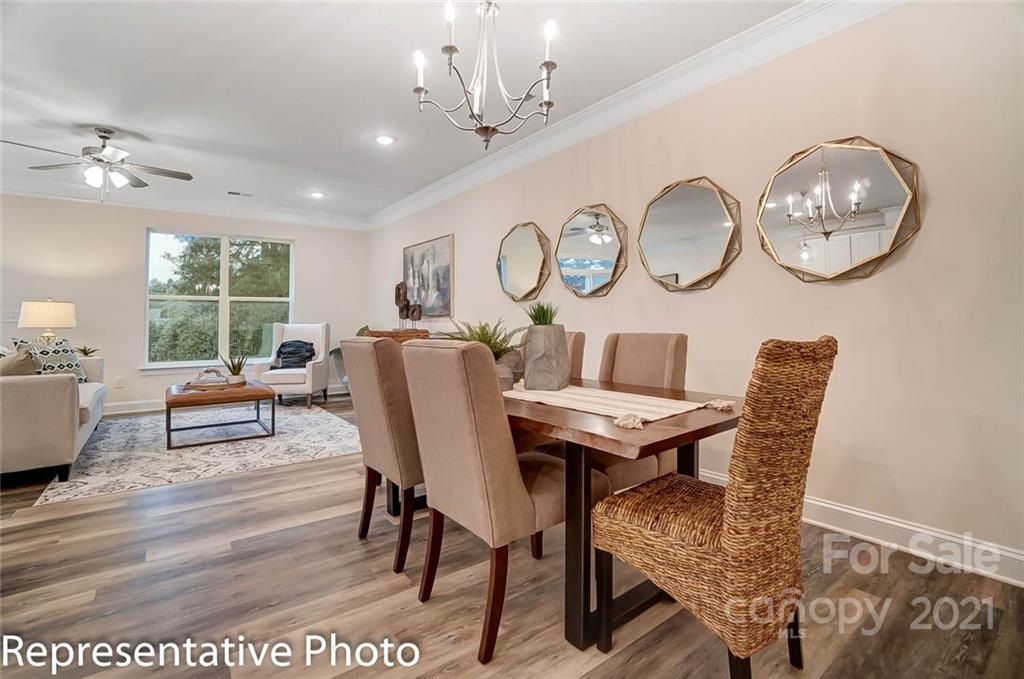 2153 Bexar Trail Matthews, NC 28105 - Photo 8 of 35 a view of a dining room with furniture window and wooden floor