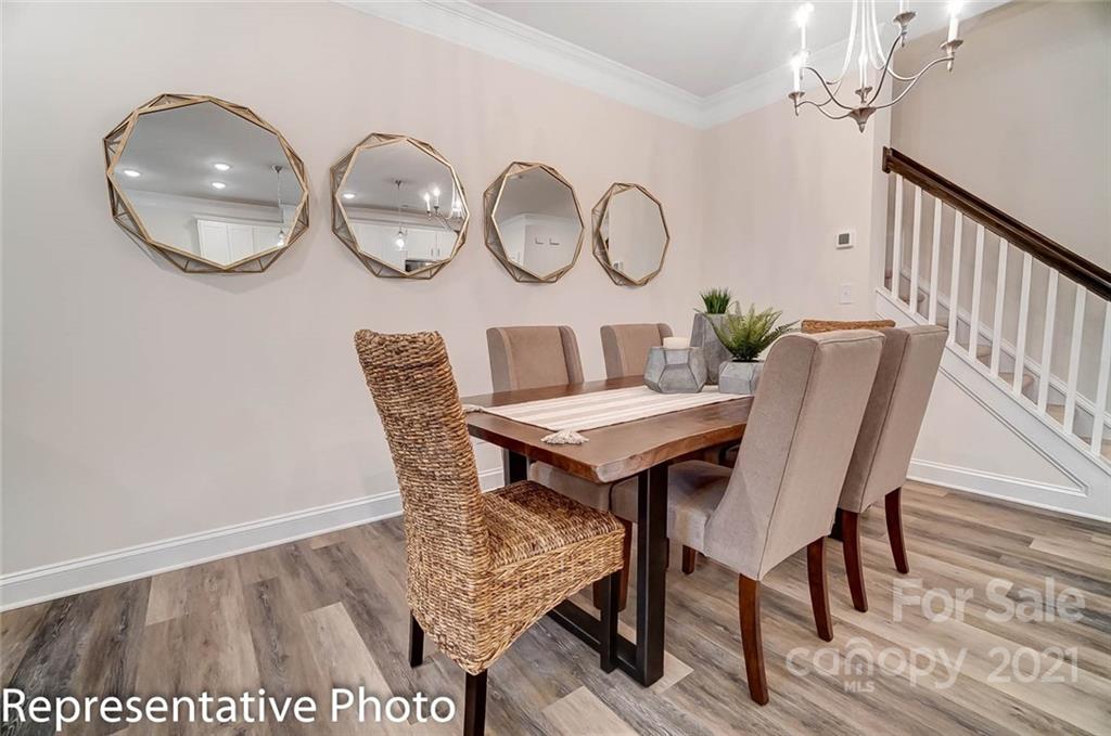 2153 Bexar Trail Matthews, NC 28105 - Photo 9 of 35 a view of a dining room with furniture and wooden floor