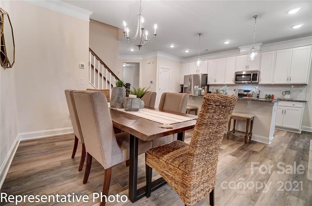 2153 Bexar Trail Matthews, NC 28105 - Photo 10 of 35 a living room with lots of furniture and kitchen view
