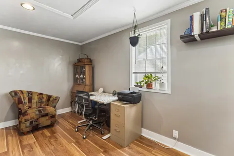 a view of workspace with wooden floor furniture