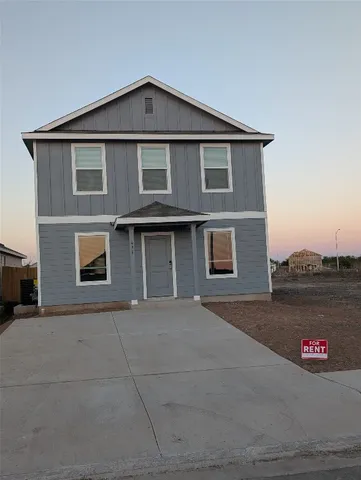 a front view of a house with a parking space