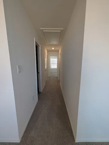 a view of a hallway with a wooden floor