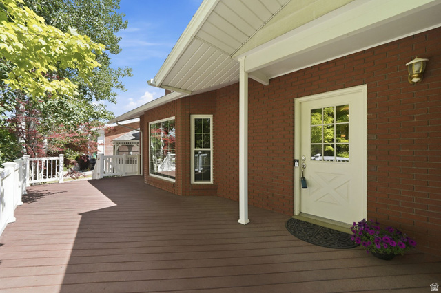 3120 North Apache Way Provo, UT 84604 - Photo 51 of 58 Spacious outdoor deck featuring wood-finish flooring, white railing, and a brick exterior