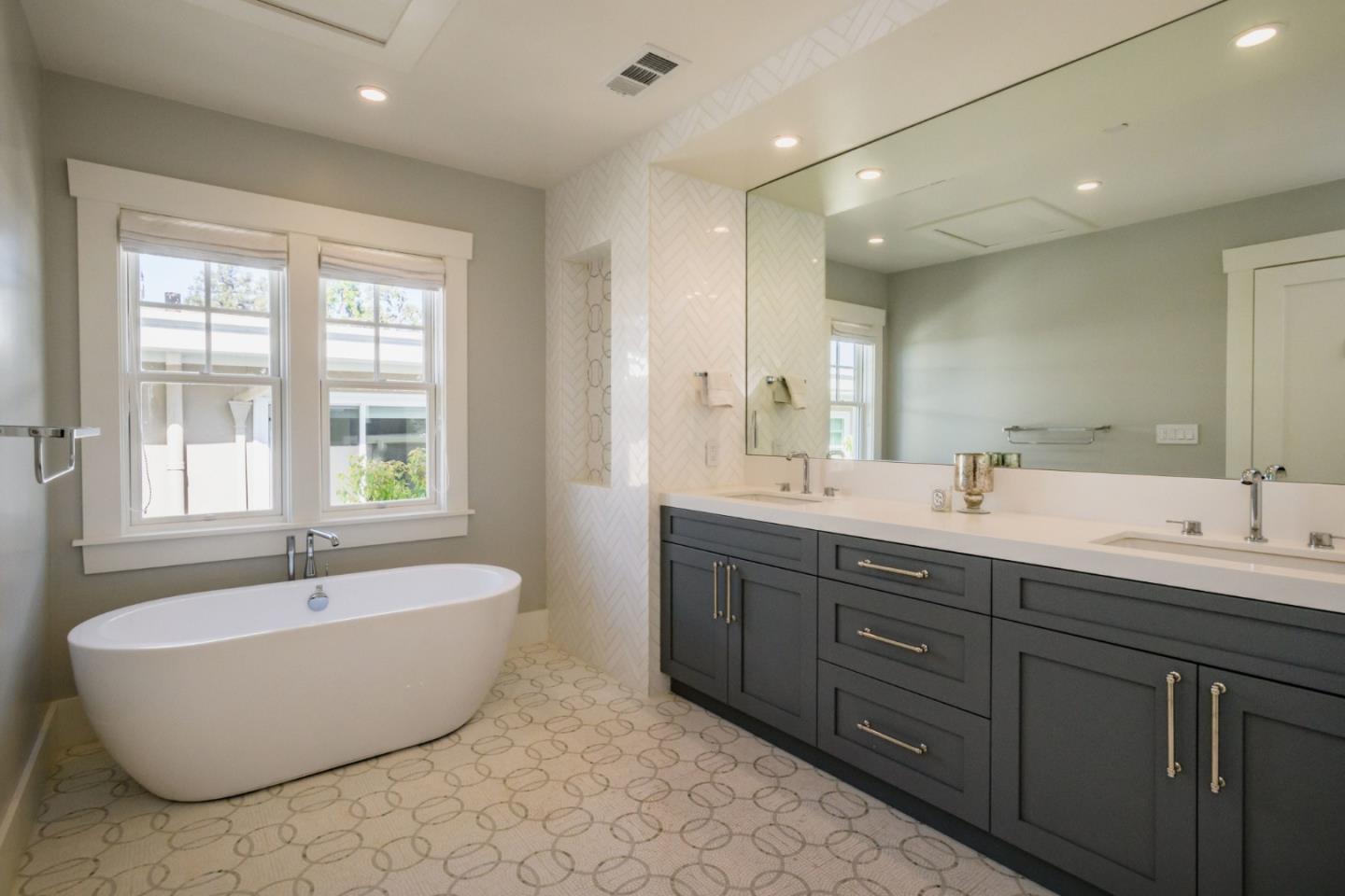 421 Hillcrest Road San Mateo, CA 94402 - Photo 21 of 33 a spacious bathroom with a tub double sink window and mirror
