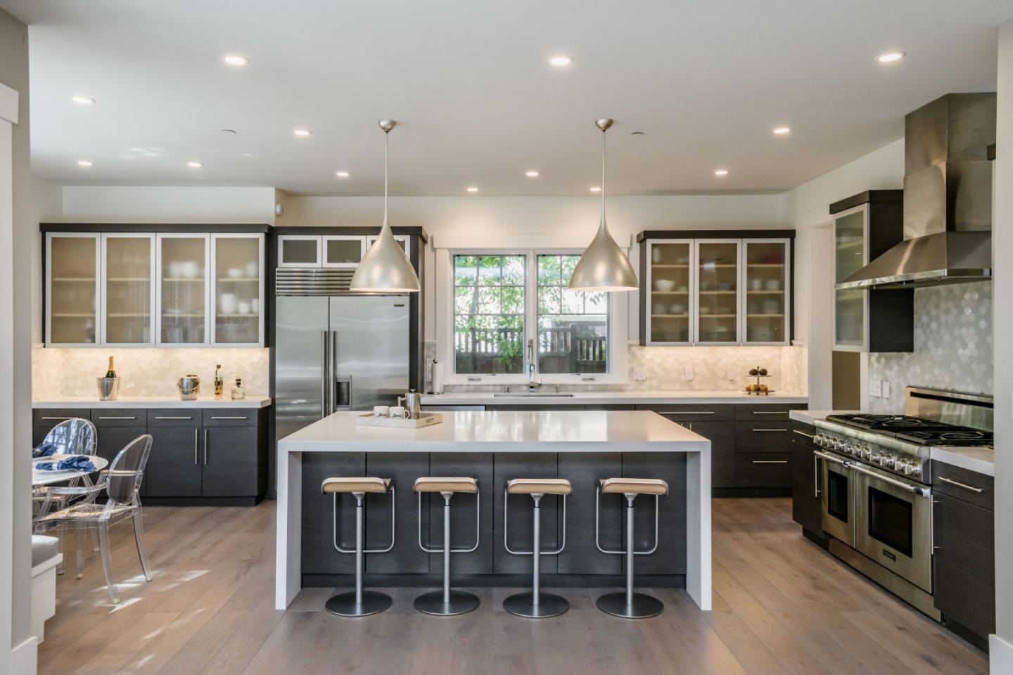 421 Hillcrest Road San Mateo, CA 94402 - Photo 7 of 33 a kitchen with stainless steel appliances granite countertop a stove and a wooden cabinets