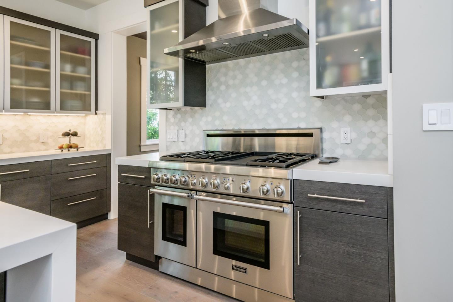 421 Hillcrest Road San Mateo, CA 94402 - Photo 9 of 33 a kitchen with stainless steel appliances granite countertop a stove and a microwave