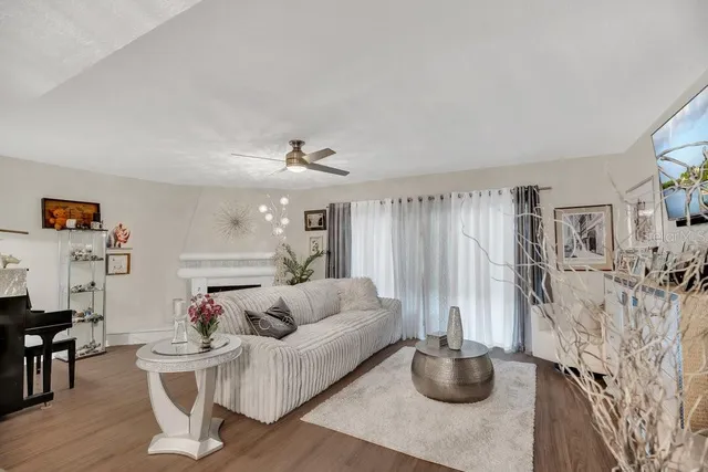 a living room with furniture and a chandelier