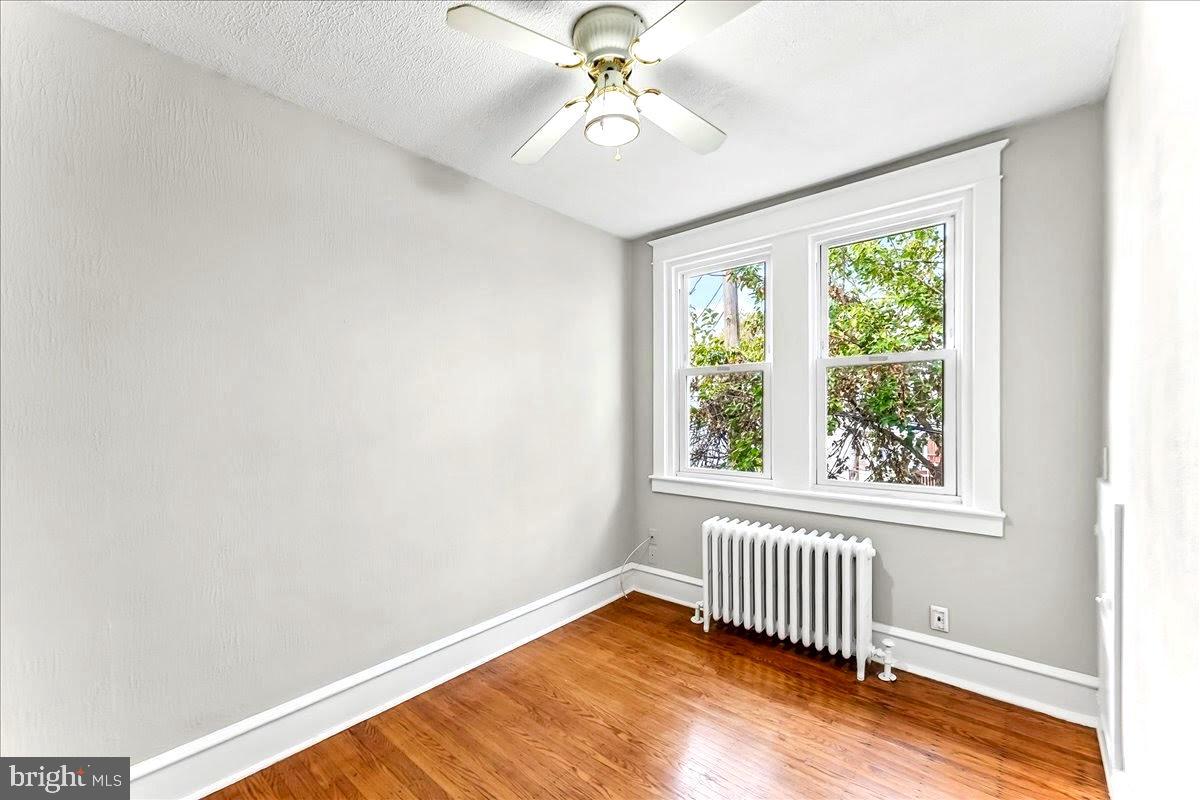 856 Chester Pike, Unit B Sharon Hill, PA 19079 - Photo 11 of 16 an empty room with a window and ceiling fan