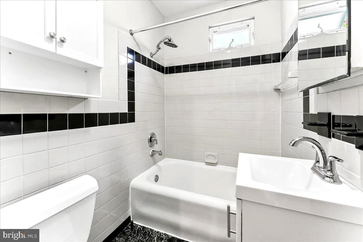 856 Chester Pike, Unit B Sharon Hill, PA 19079 - Photo 15 of 16 a bathroom with a sink and a bathtub