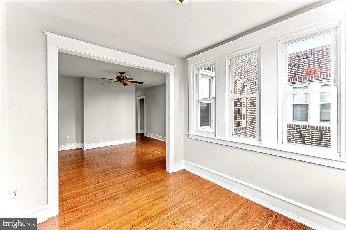856 Chester Pike, Unit B Sharon Hill, PA 19079 - Photo 5 of 16 a view of an empty room with wooden floor and a window
