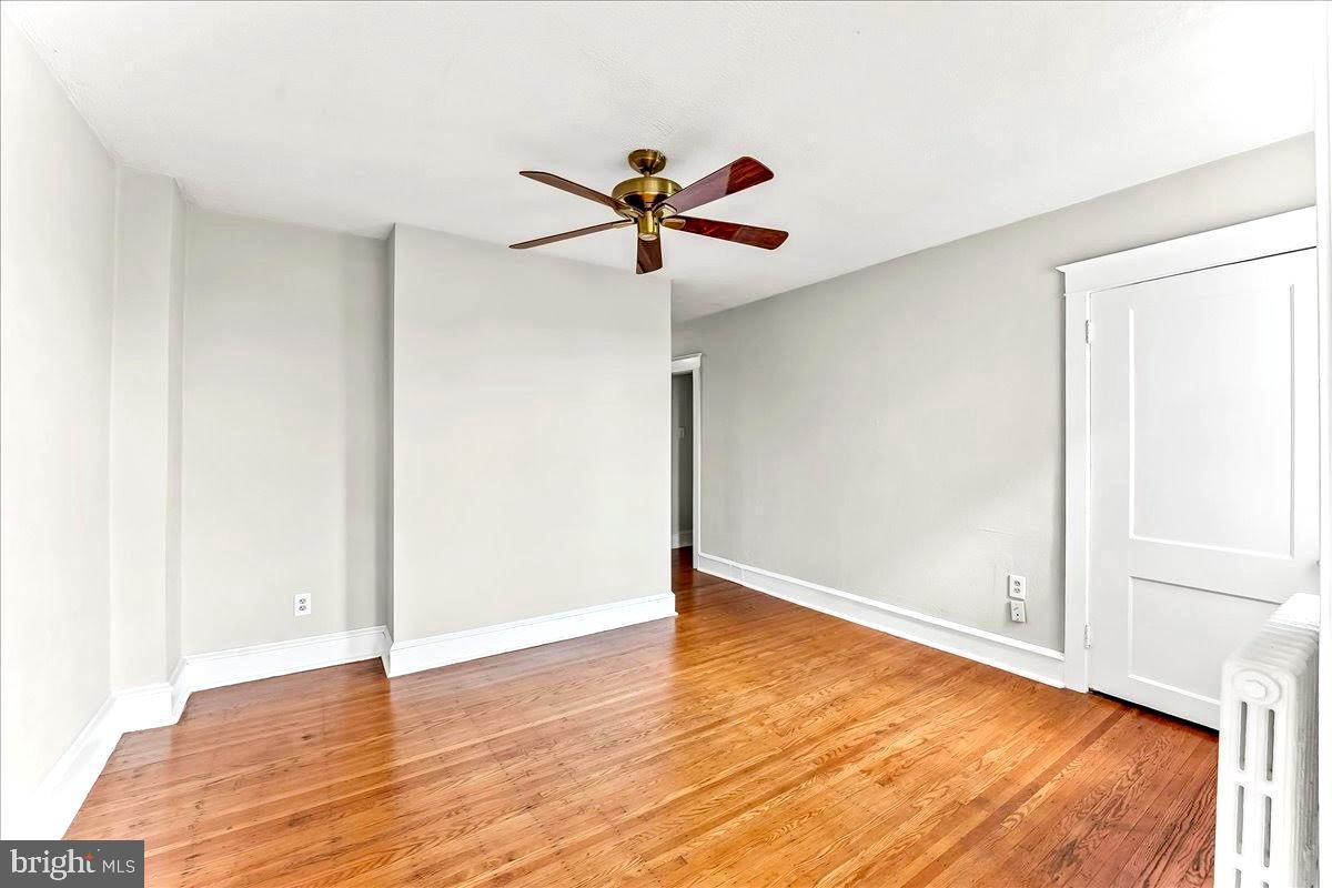 856 Chester Pike, Unit B Sharon Hill, PA 19079 - Photo 7 of 16 a view of a room with wooden floor and a ceiling fan