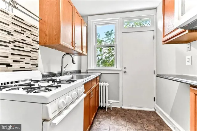a kitchen with stainless steel appliances a stove a sink and a refrigerator