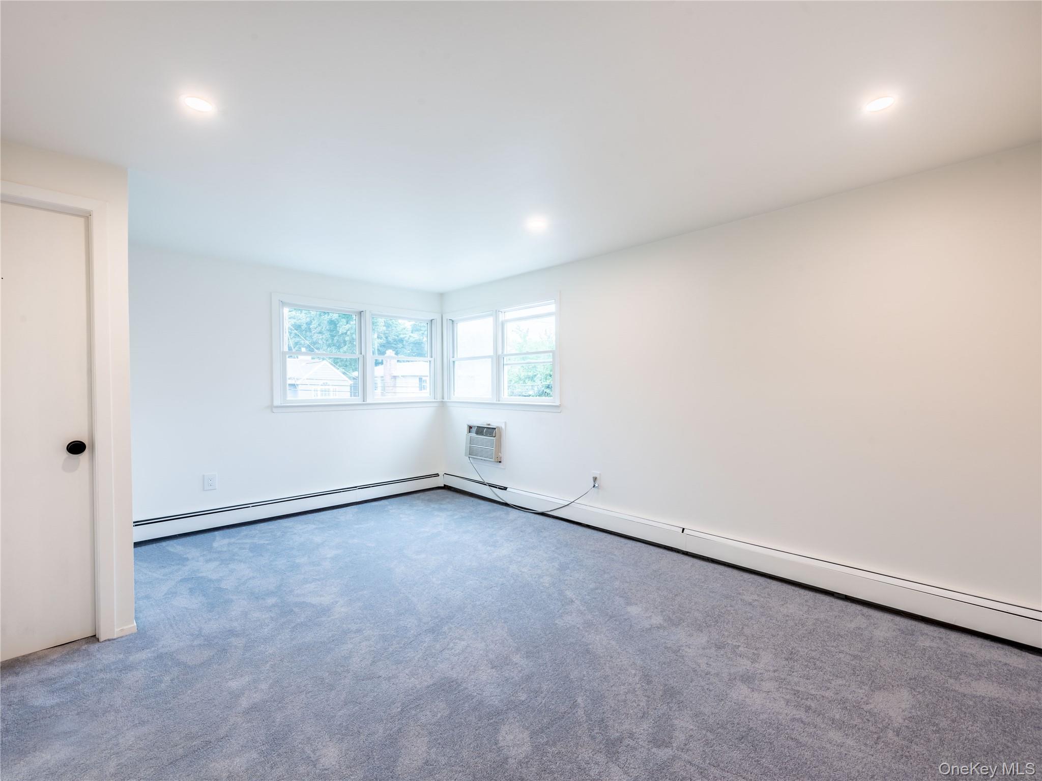 47 Edgewood Road Port Washington, NY 11050 - Photo 21 of 22 an empty room with windows