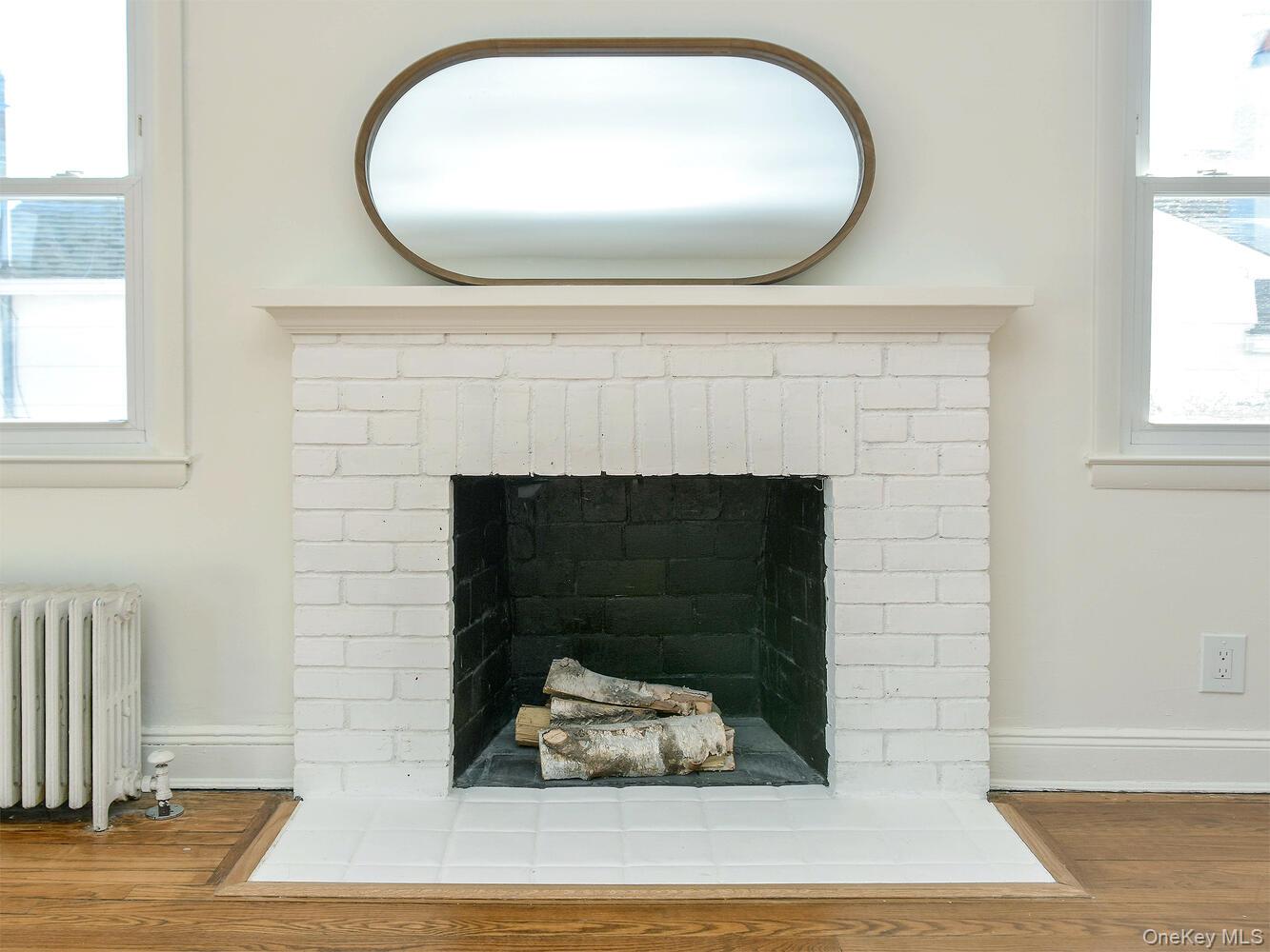 47 Edgewood Road Port Washington, NY 11050 - Photo 4 of 22 view of a livingroom with fireplace and window