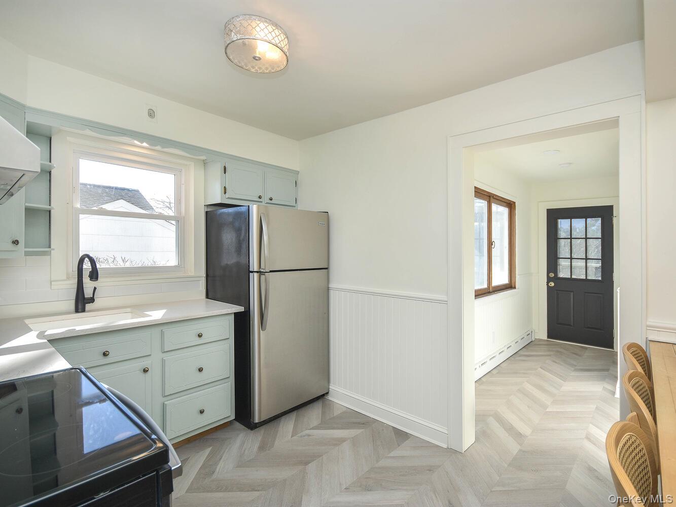 47 Edgewood Road Port Washington, NY 11050 - Photo 5 of 22 a kitchen with a refrigerator and a sink