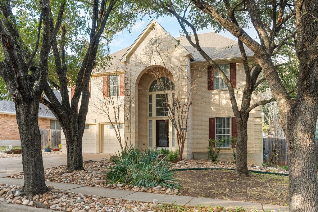 1406 Dapplegrey Lane Austin, TX 78727 - Photo 2 of 38 Traditional-style home featuring brick siding, concrete driveway, an attached garage, and roof with shingles