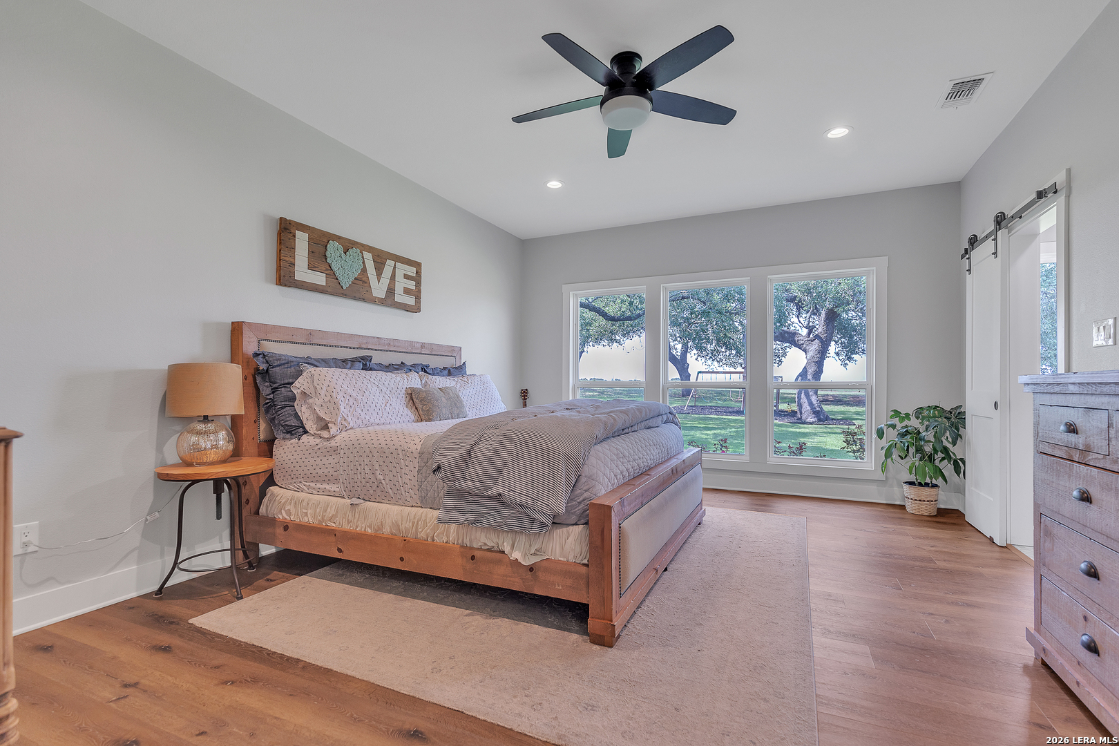 1026 Timbercrest Pleasanton, TX 78064 - Photo 12 of 37 a spacious bedroom with a bed window and a potted plant