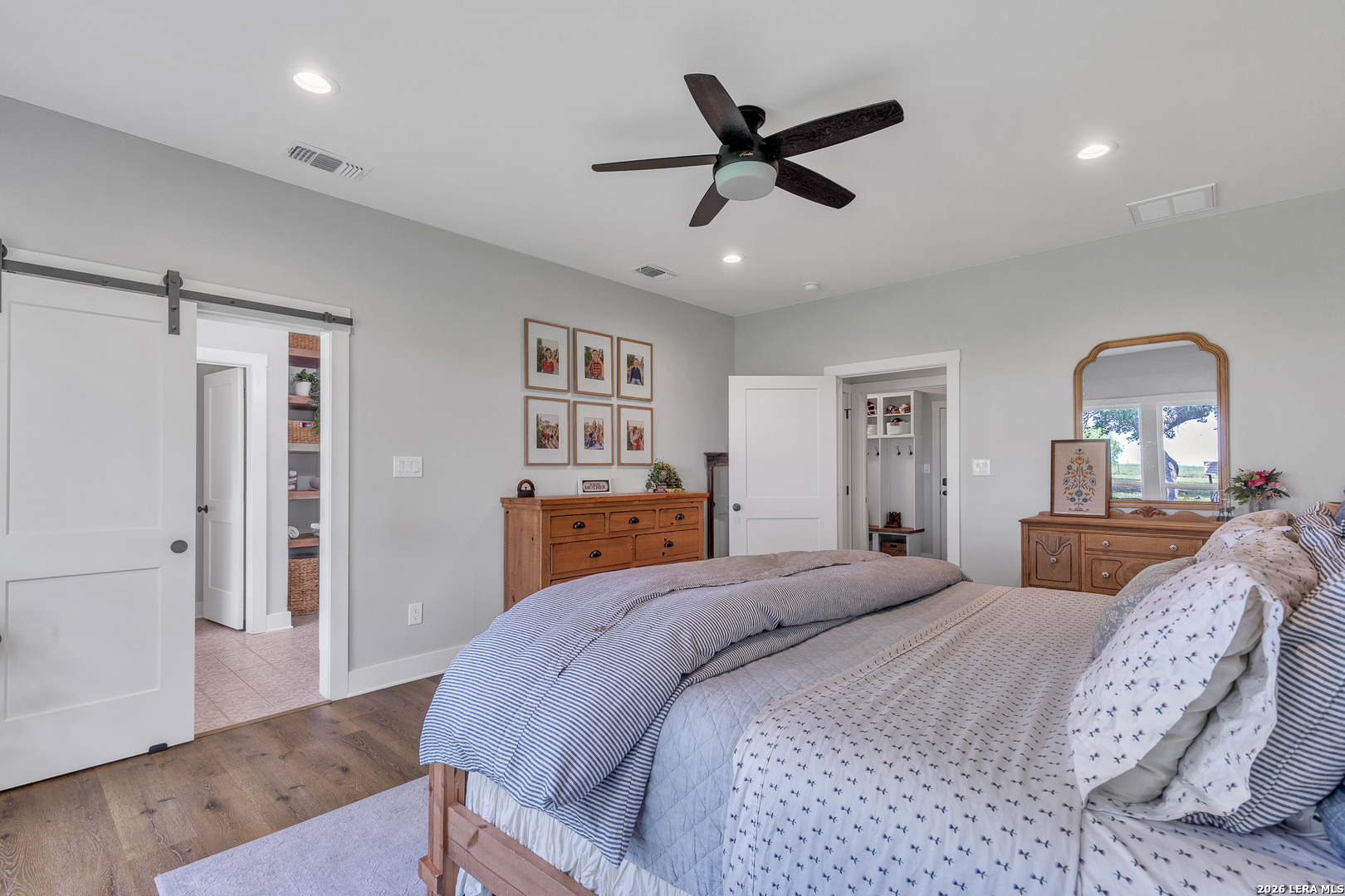 1026 Timbercrest Pleasanton, TX 78064 - Photo 14 of 37 a bedroom with a bed and a mirror on the dresser