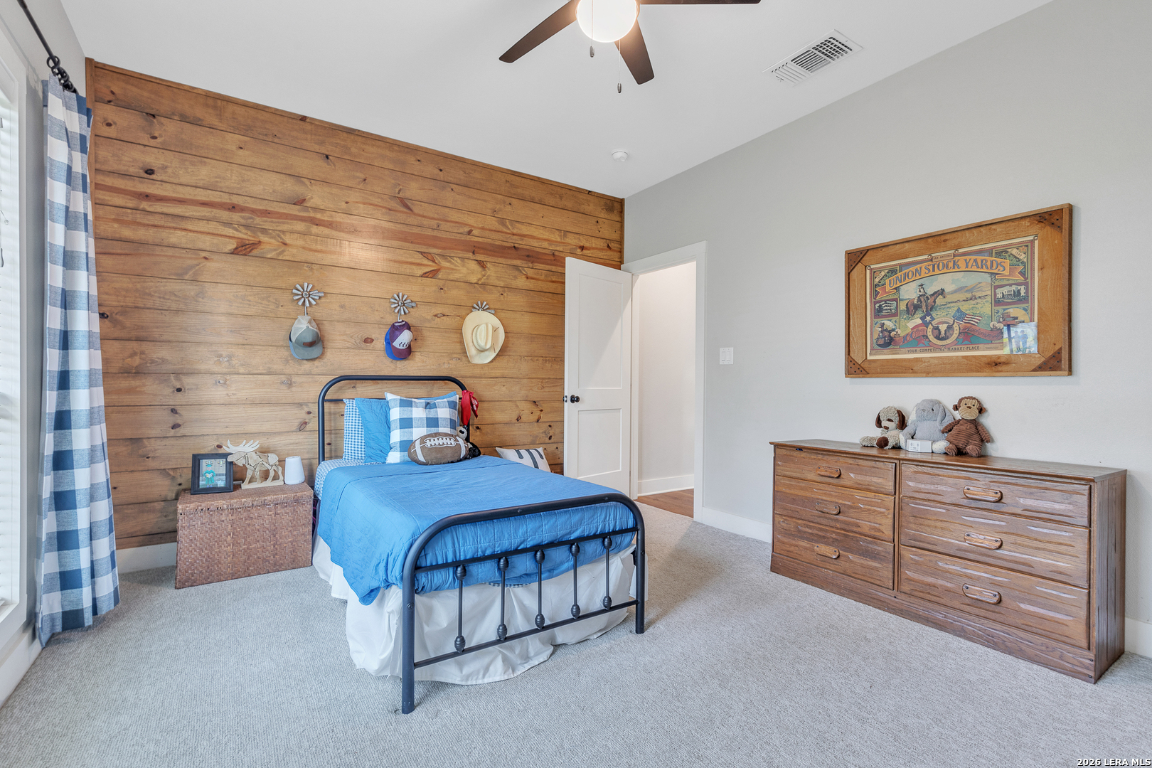 1026 Timbercrest Pleasanton, TX 78064 - Photo 24 of 37 a bedroom with a bed and a chandelier
