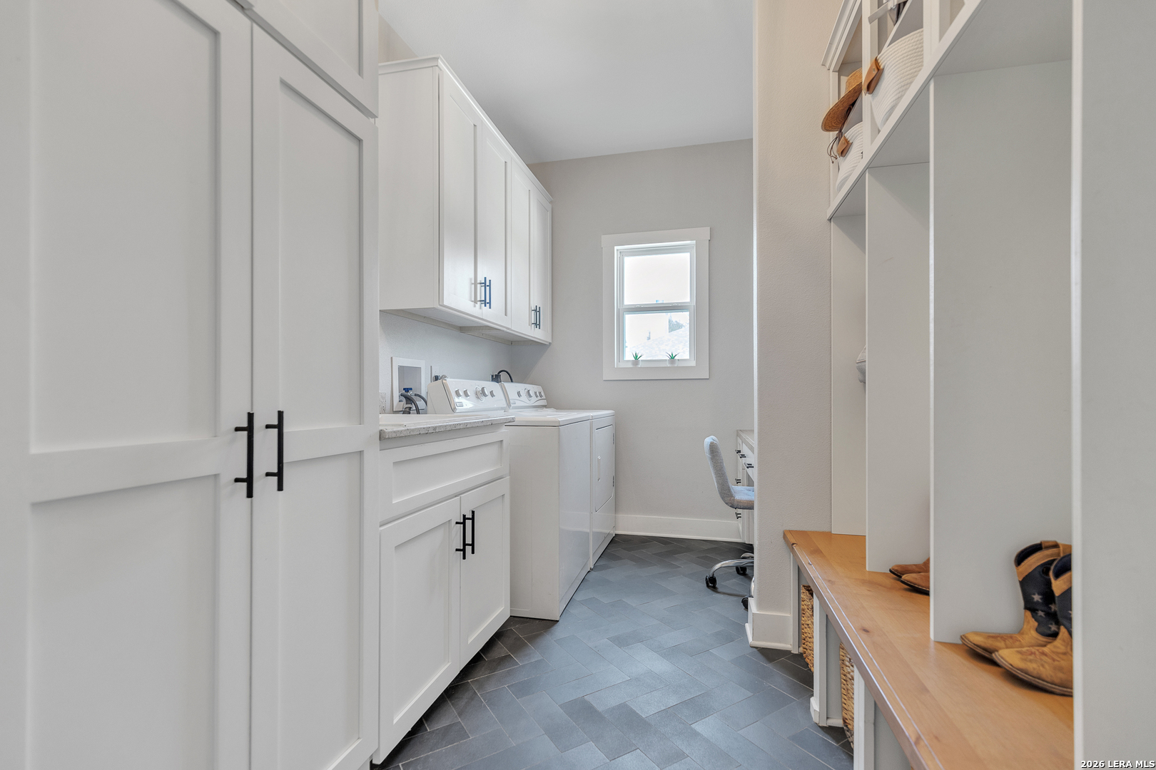 1026 Timbercrest Pleasanton, TX 78064 - Photo 26 of 37 a room with white cabinets and clock on the wall