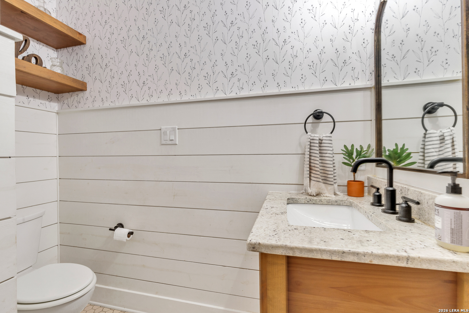 1026 Timbercrest Pleasanton, TX 78064 - Photo 27 of 37 a bathroom with a granite countertop sink and a toilet