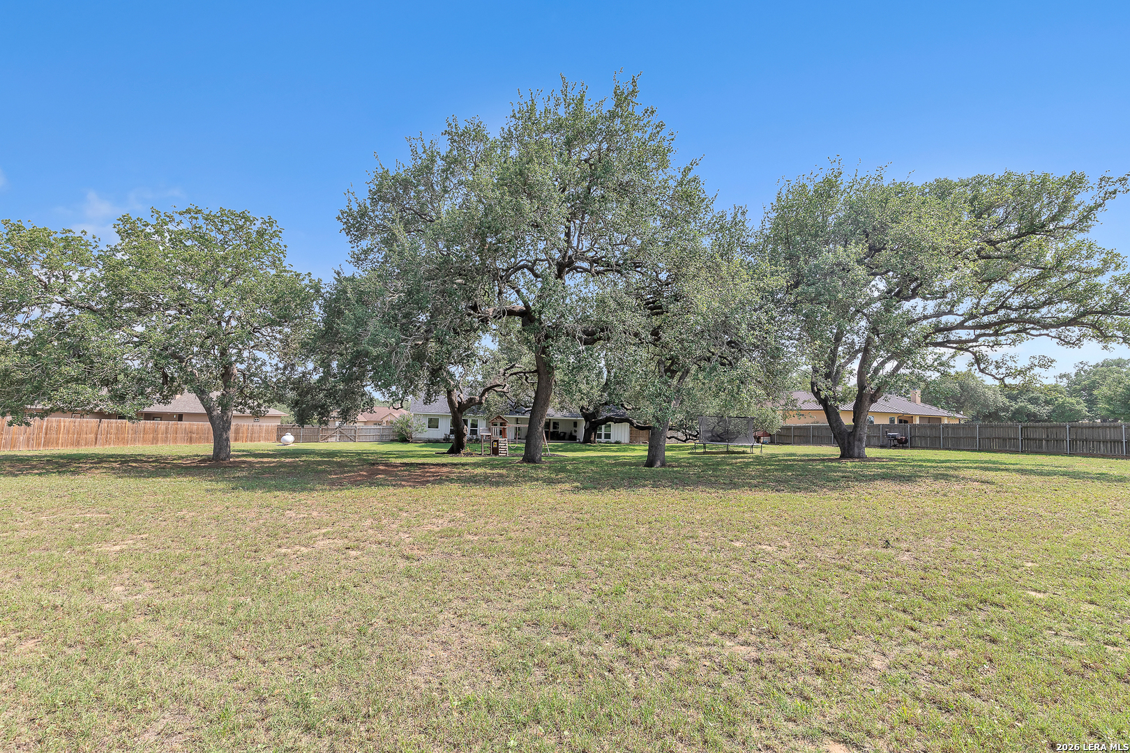 1026 Timbercrest Pleasanton, TX 78064 - Photo 35 of 37 a yard with trees in the background