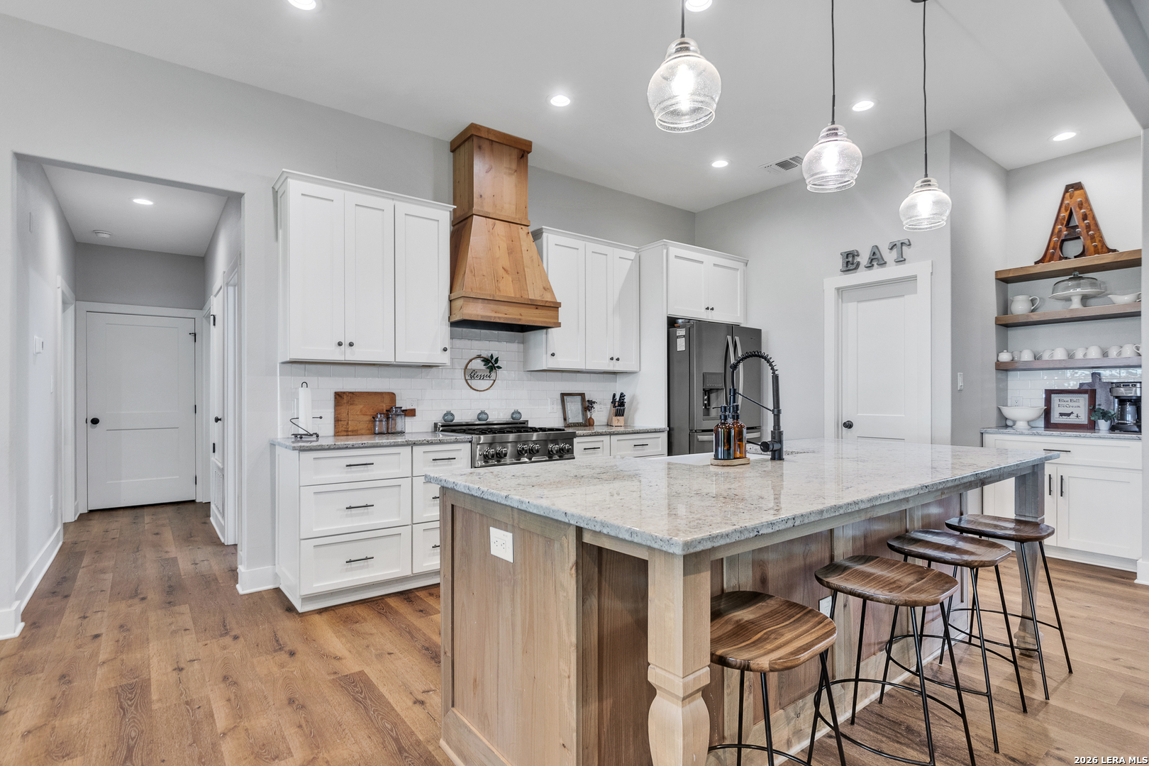 1026 Timbercrest Pleasanton, TX 78064 - Photo 8 of 37 a kitchen with kitchen island granite countertop a stove a sink a center island and cabinets