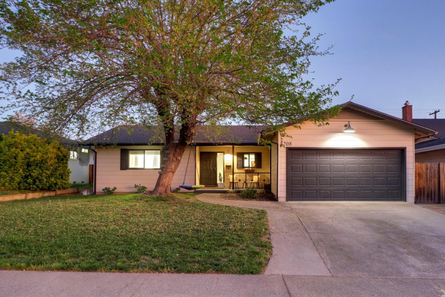 5208 Rambler Way Sacramento, CA 95841 - Photo 11 of 51 a front view of a house with a yard and garage