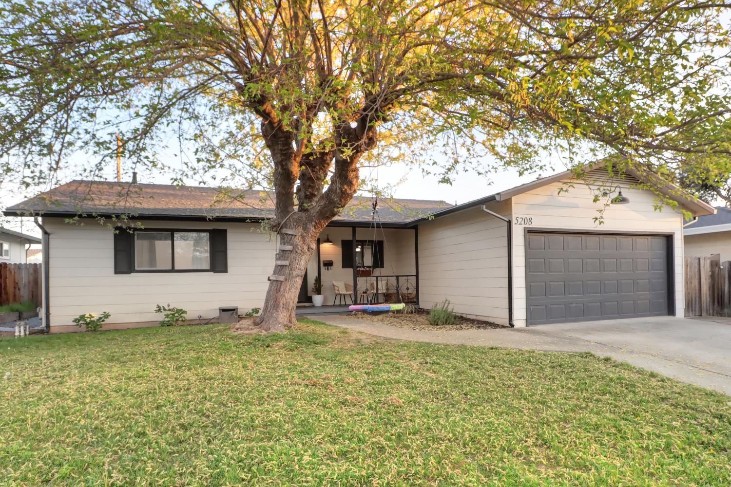 5208 Rambler Way Sacramento, CA 95841 - Photo 12 of 51 a front view of a house with a yard and garage