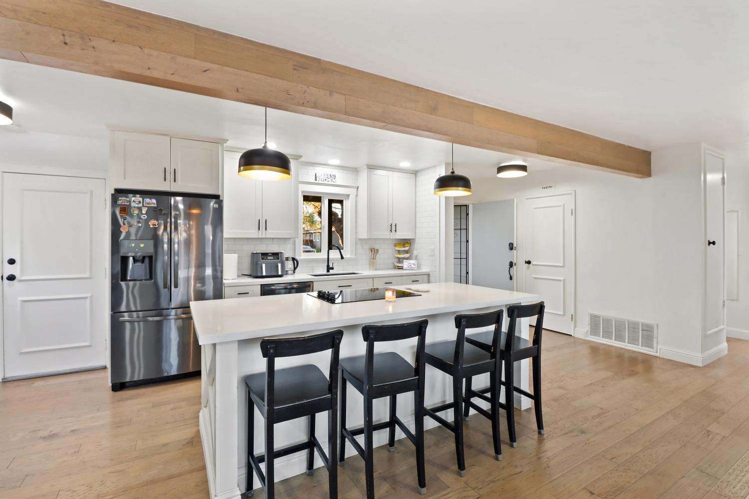 5208 Rambler Way Sacramento, CA 95841 - Photo 20 of 51 a kitchen with a dining table chairs and refrigerator